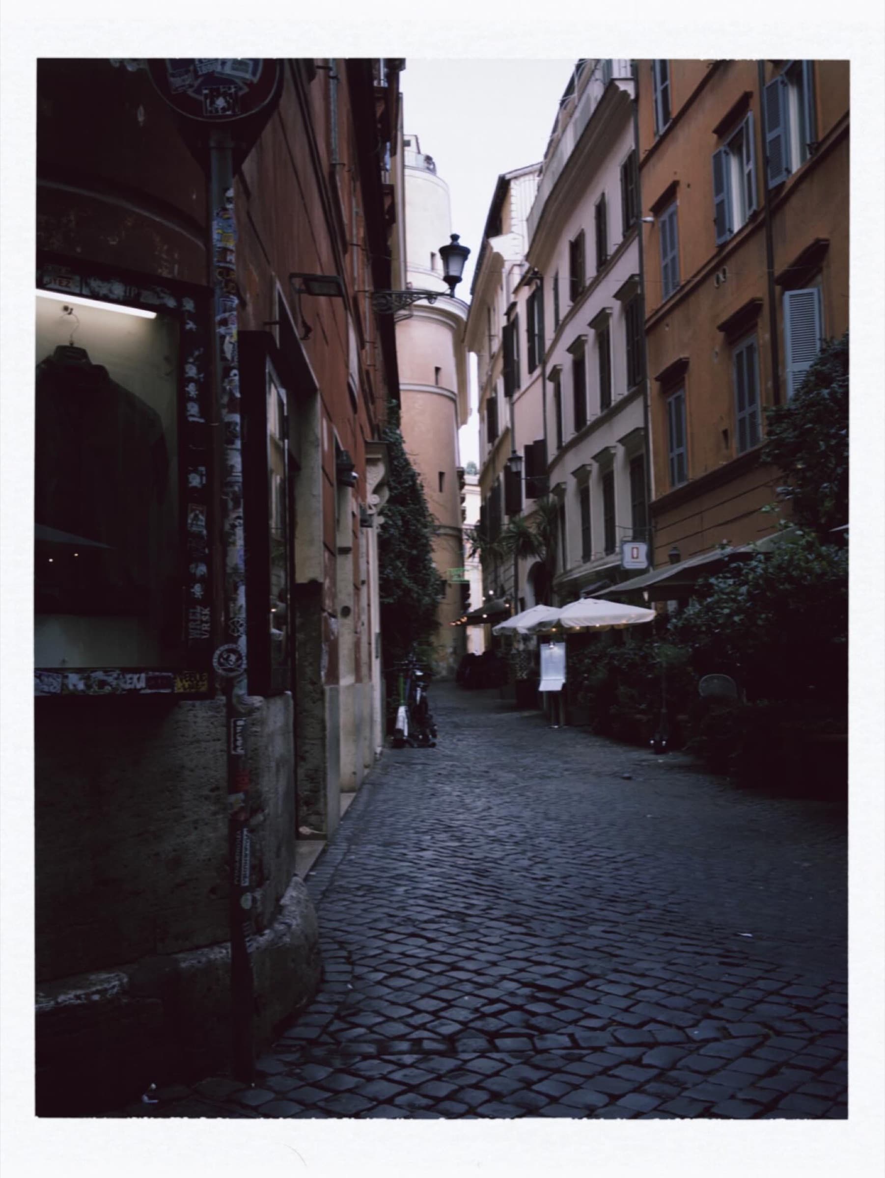 A shaded narrow street between old buildings